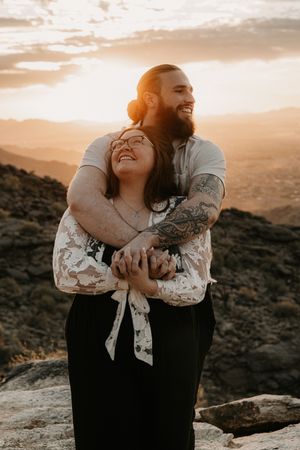 Engagement portraits captured in the Arizona mountains during golden hour lighting.