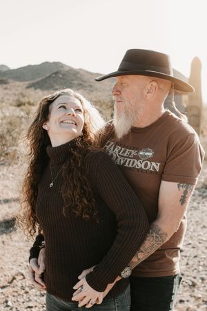 Couple sharing a quiet moment beneath glowing desert skies in Arizona.