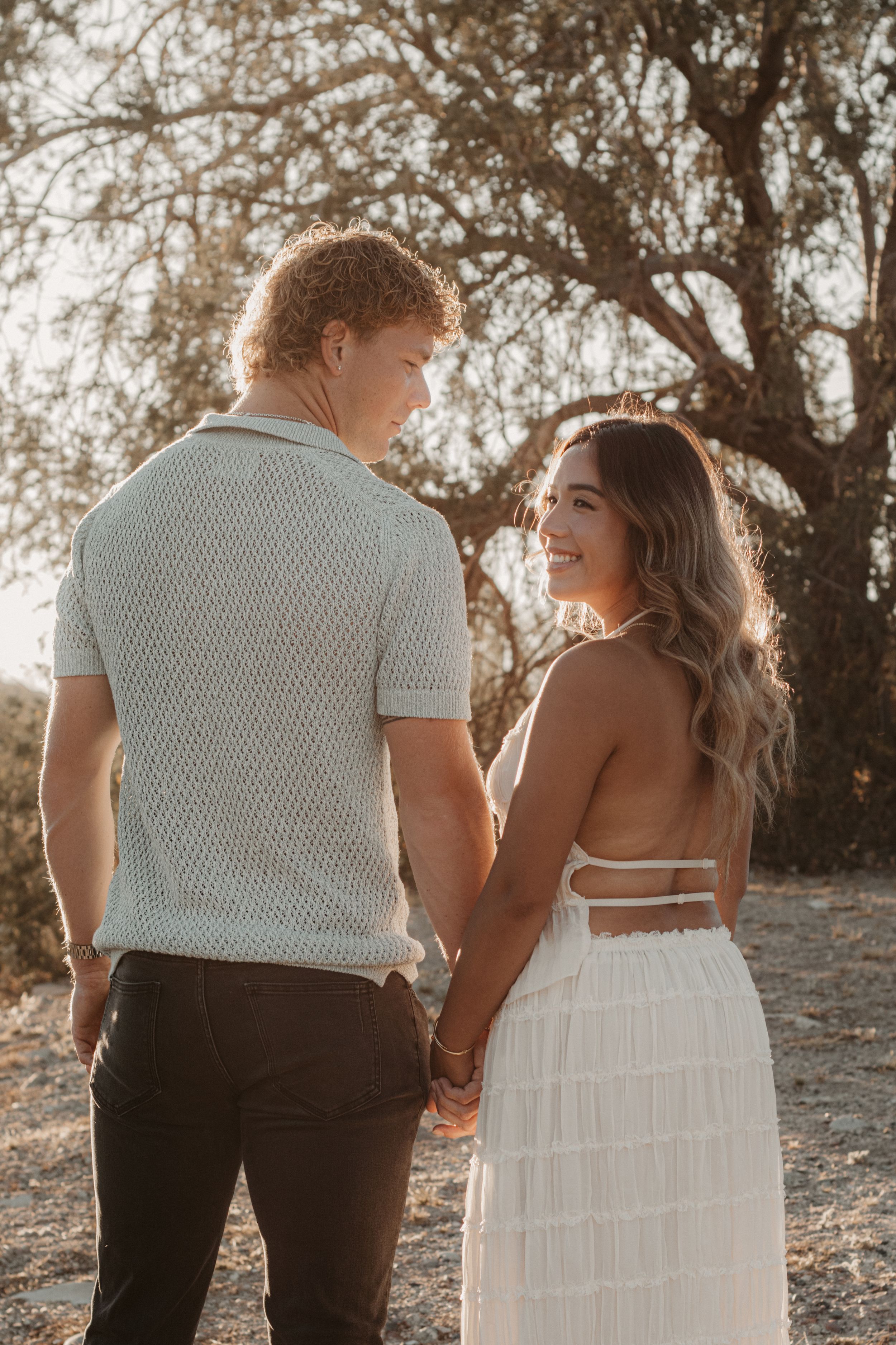 Couple photographed together beneath the mountains during sunset in Arizona.
