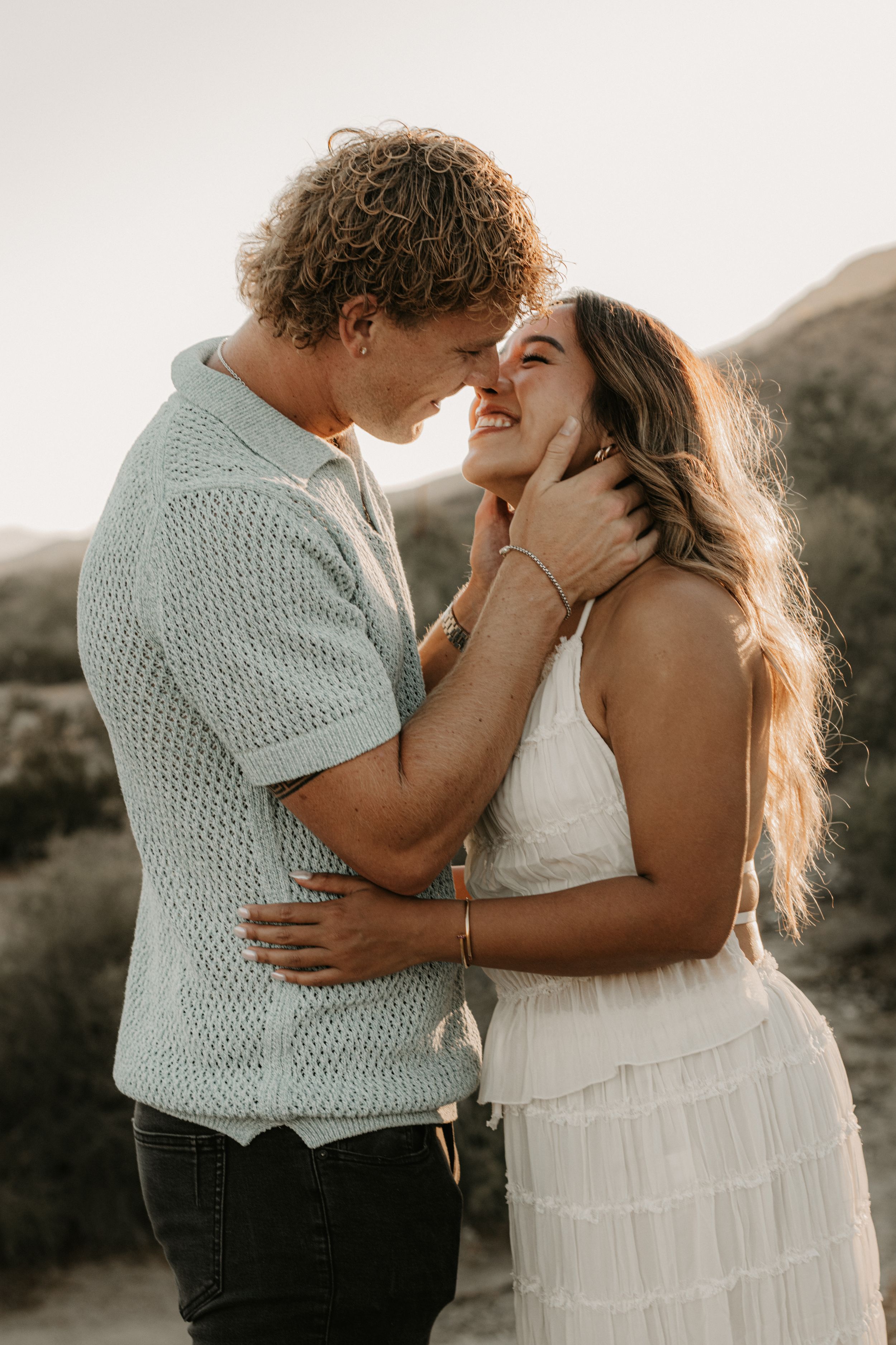 Couple embracing together during golden hour portraits in the Arizona mountains.