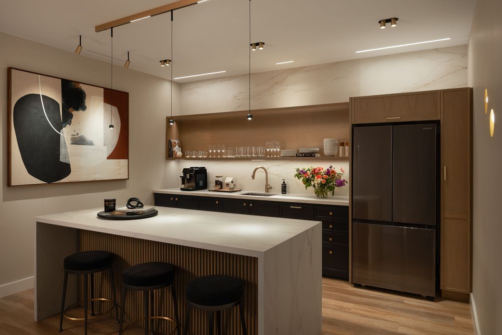 Modern kitchen design features sleek cabinetry, pendant lighting, and a minimalist white island with bar seating.