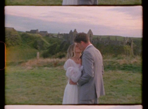 Windswept eloping couple at Dunluce Castle in Northern Ireland on Super 8 film
