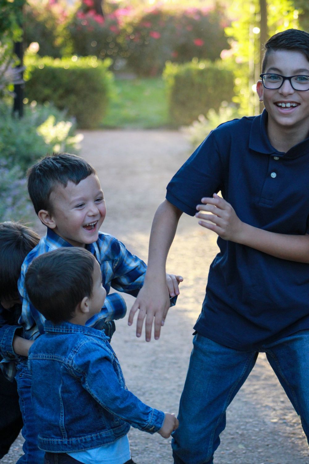 Joyful moment captured in garden setting with children laughing together.