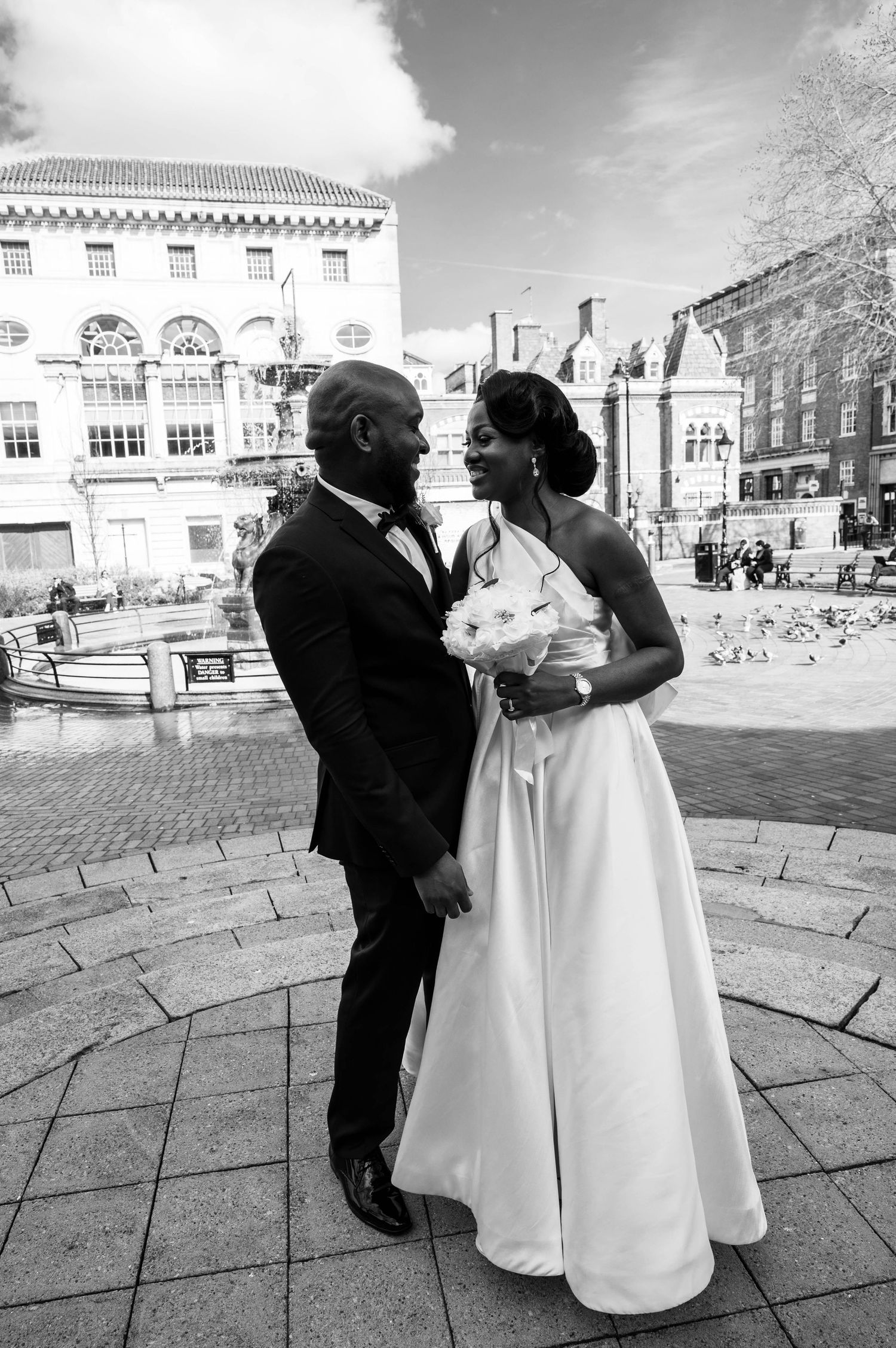 Weekday wedding ceremony, couple outside Leicester Registry Office in front of the Leicester fountain