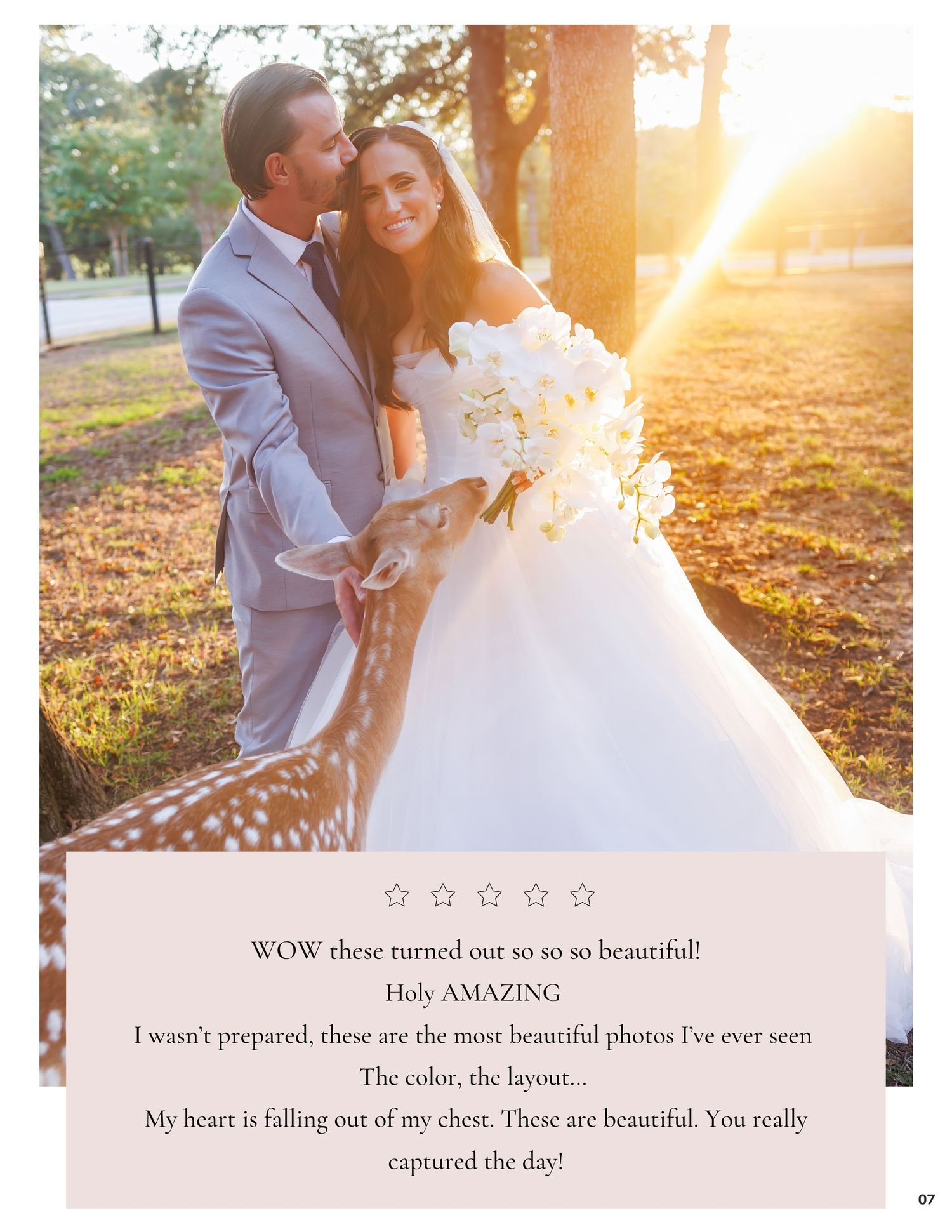 A bride in a white ball gown and groom in a gray suit embrace outdoors with sunlight glowing behind them.