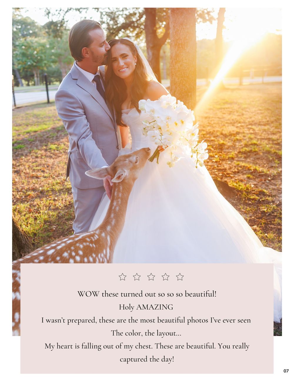 A bride in a white ball gown and groom in a gray suit embrace outdoors with sunlight glowing behind them.