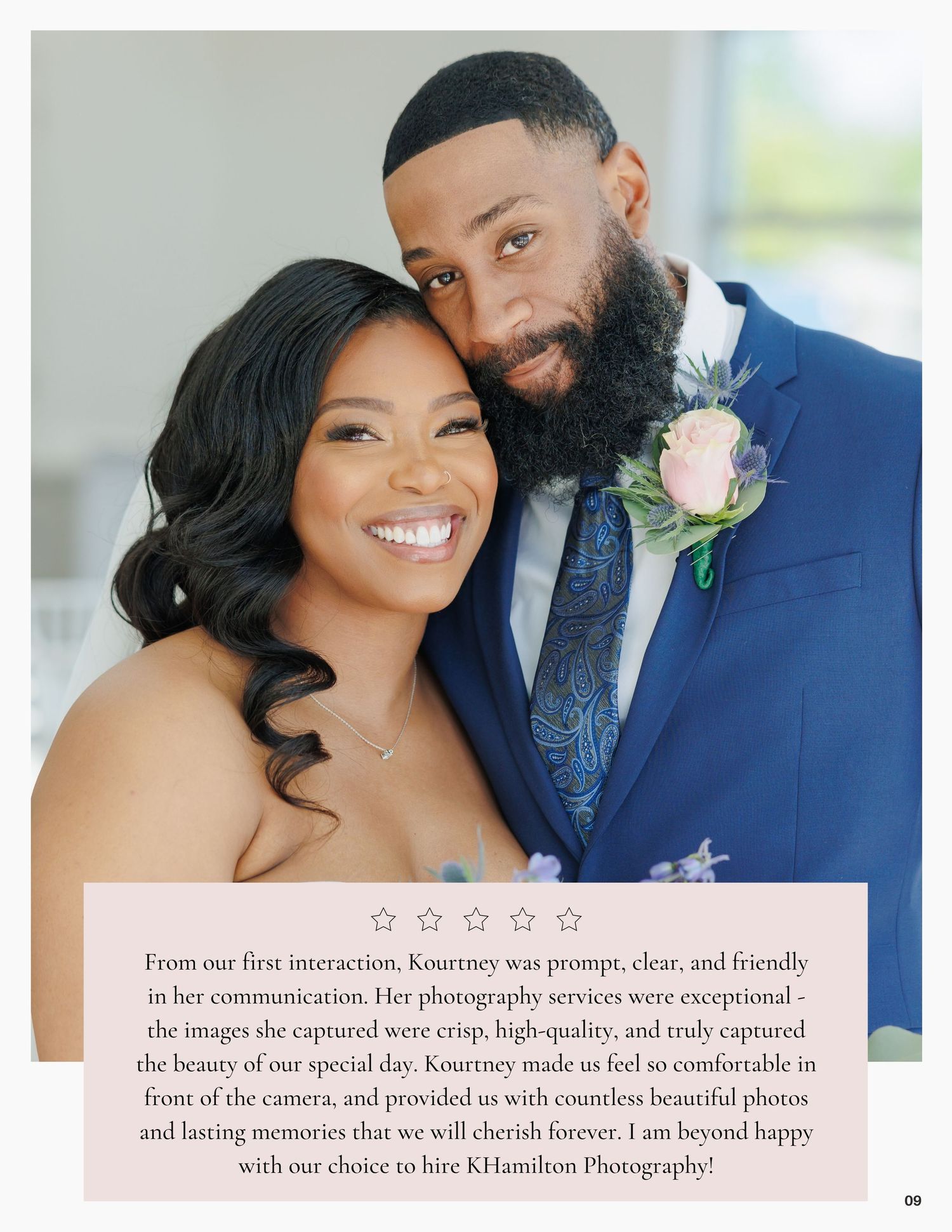 Happy newlywed couple posing for wedding portrait, bride in white gown and groom in navy suit with floral boutonniere.