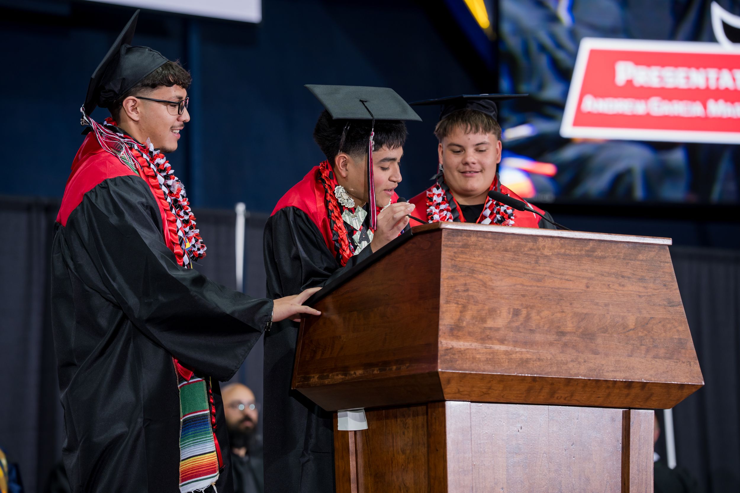 White banner displaying Coconino High School's panther mascot and motto 'Believe to Succeed' at podium. Yadira Ortiz Soto presents.