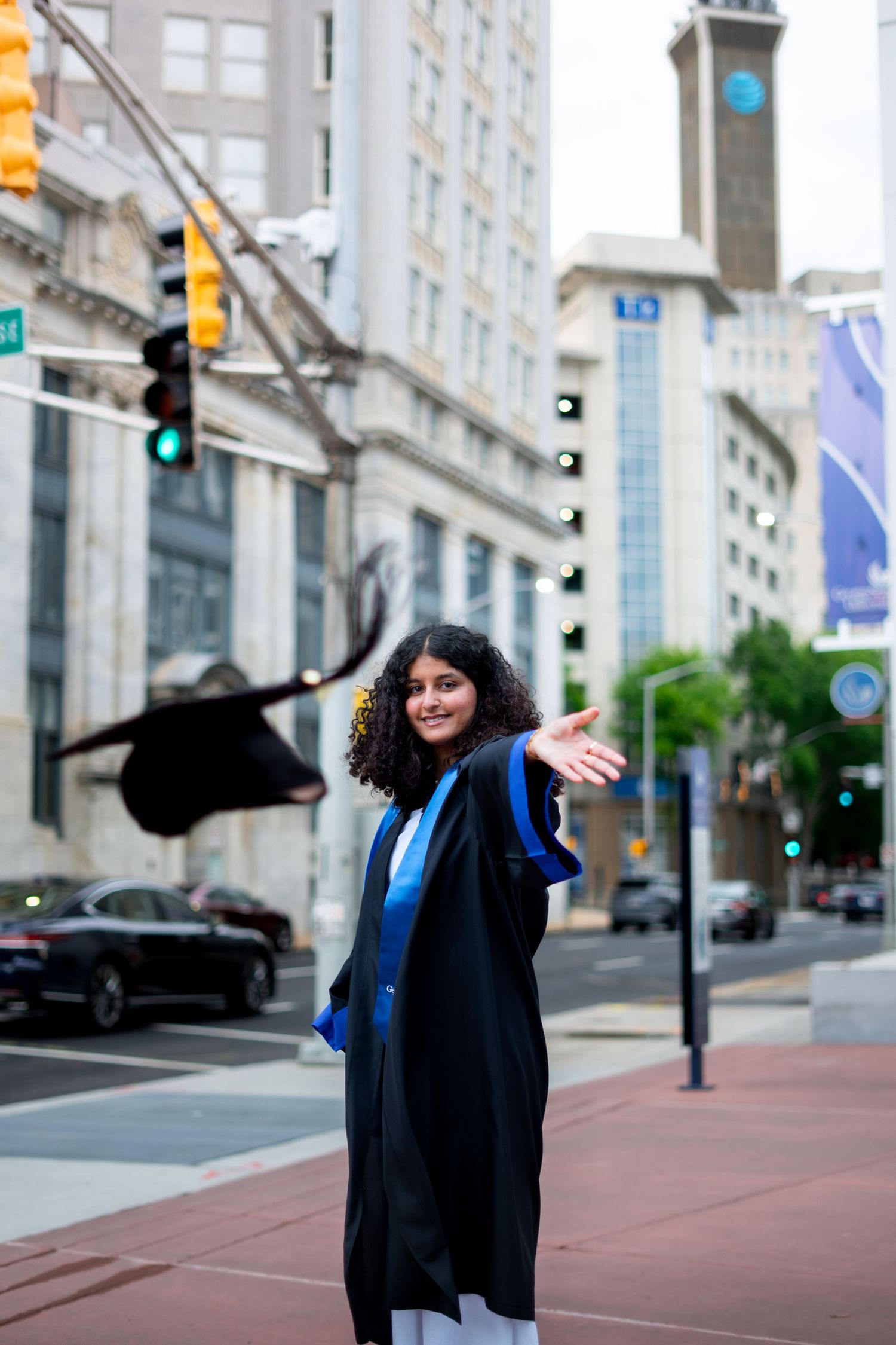 Georgia State graduation photos in front of the atlanta cityscape with GSU branding, one of the best spots on the Atlanta campus