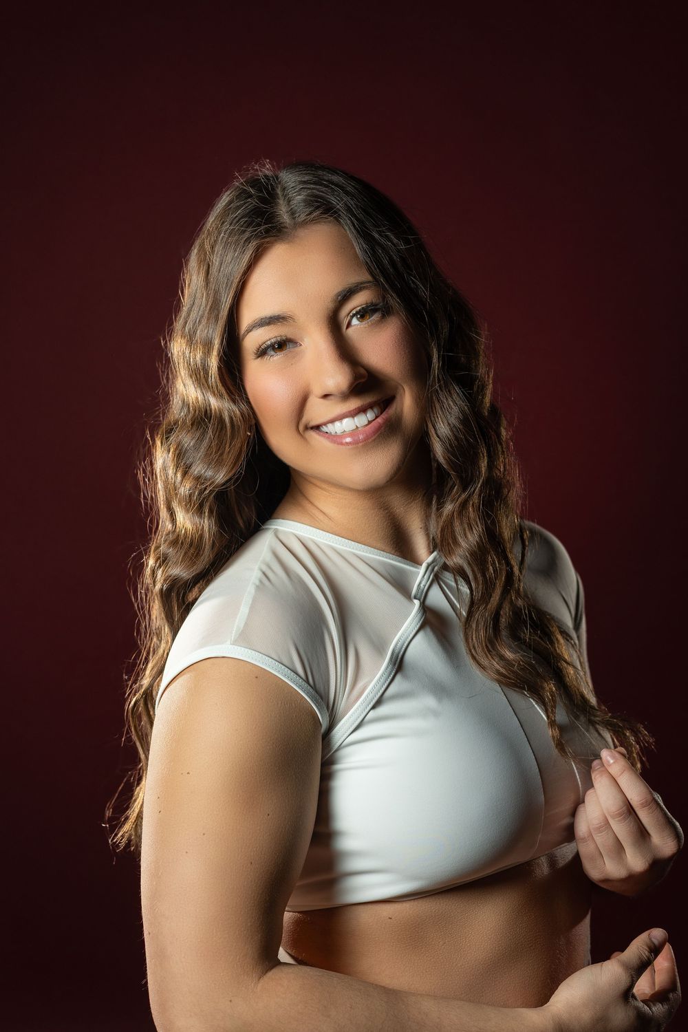 A series of professional boudoir photographs featuring a person in a white top against a dark background.