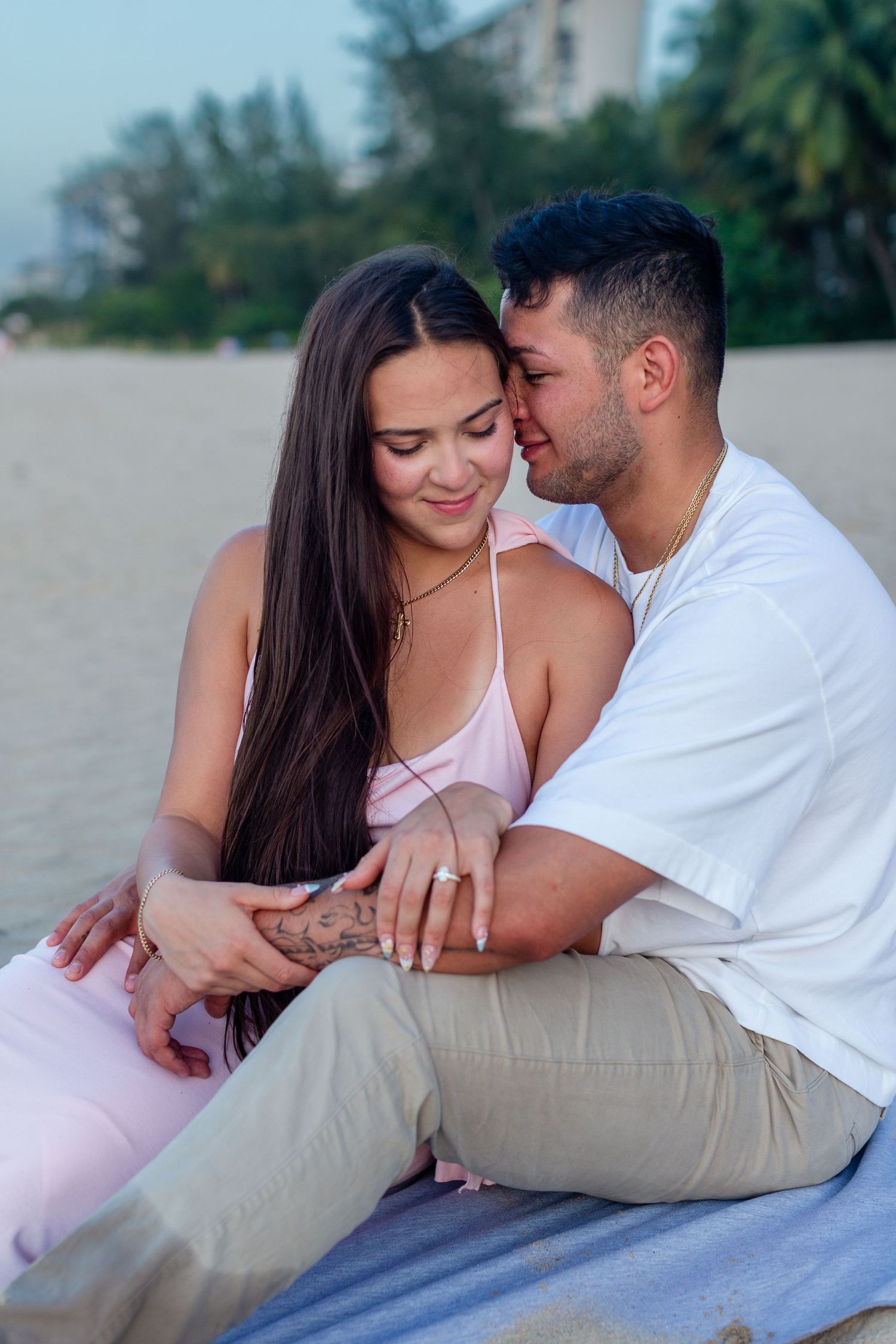 Couples portrait seated at the beach in Isla Verde, Carolina, Puerto Rico.