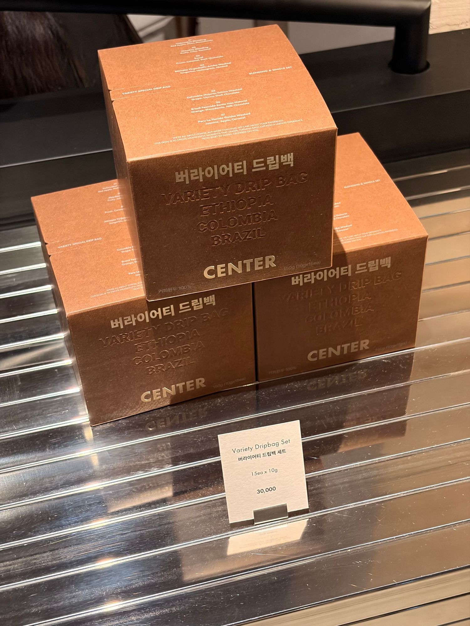 Stack of Korean CENTER variety dream pack boxes displayed on a glass shelf with a price tag.