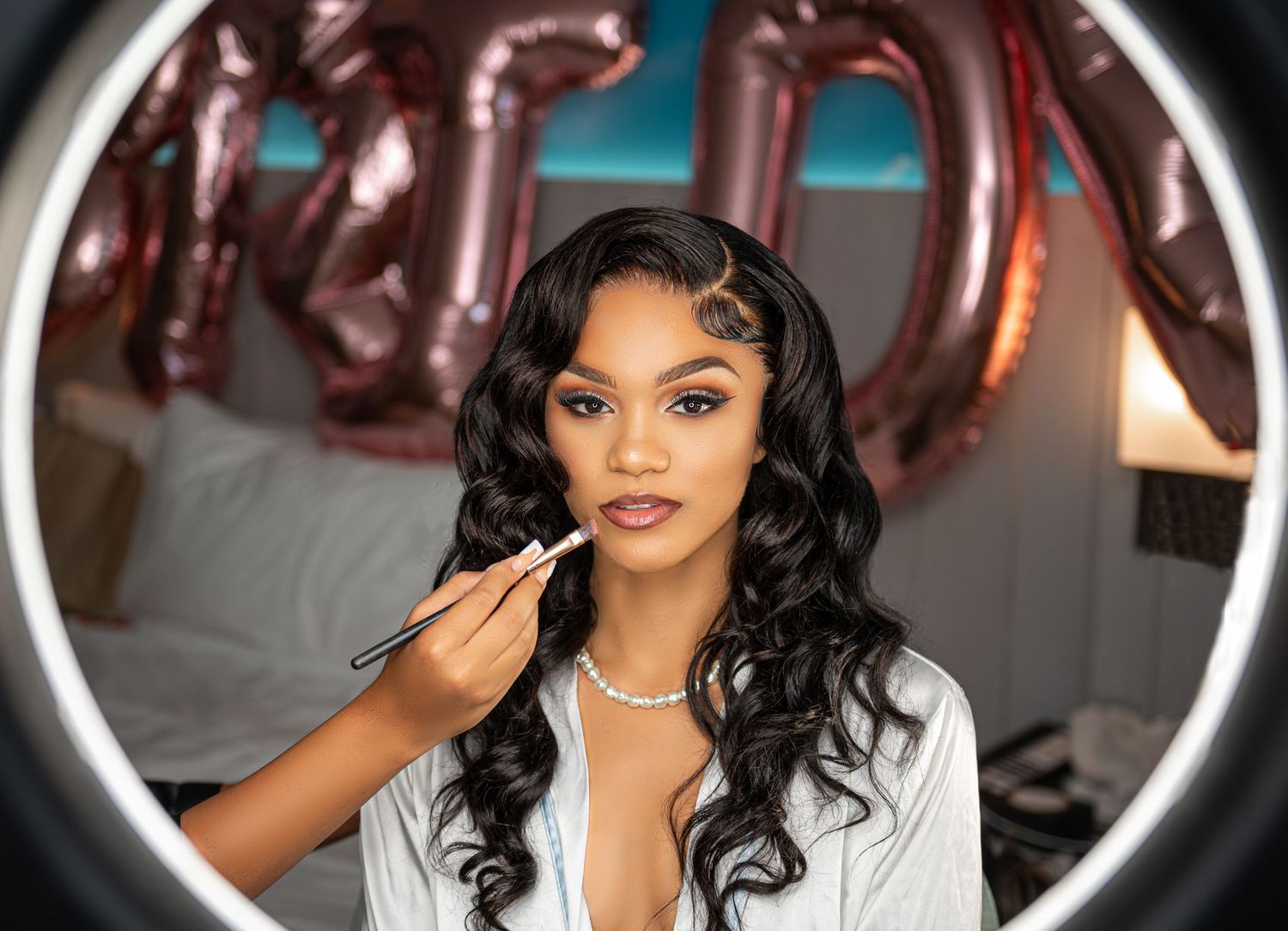 This bride-to-be awaits her touch-up with anticipation, photographed by luxury wedding photographers.