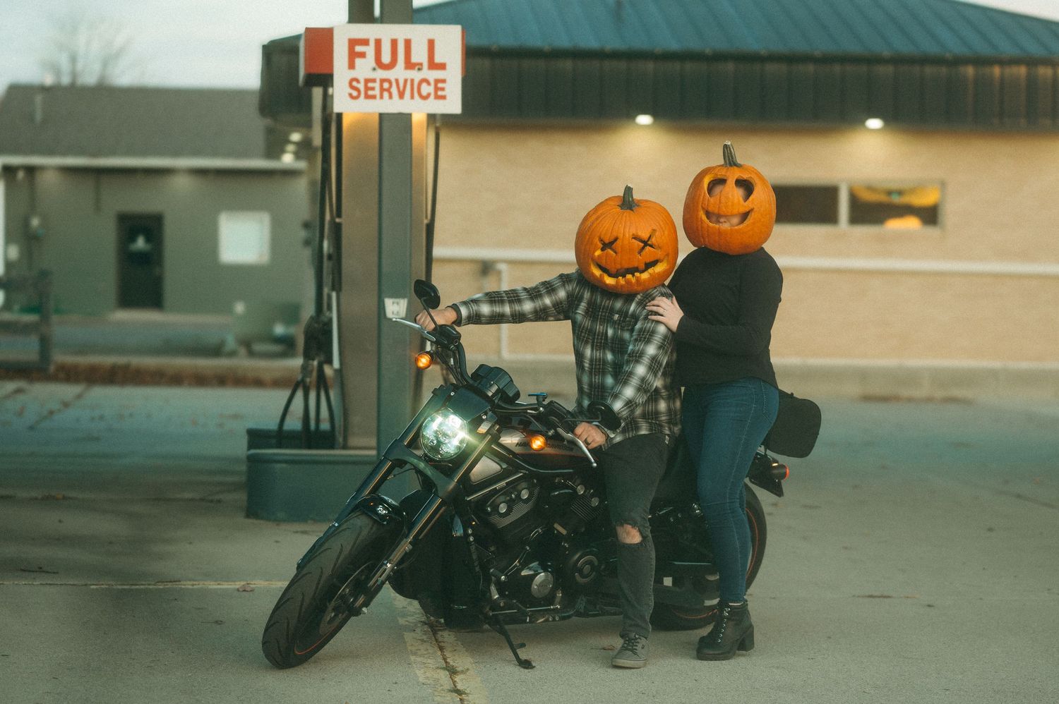 Creative Halloween couples session with pumpkin heads, motorcycle styling and a romantic fall-inspired editorial feel in Brookings SD.