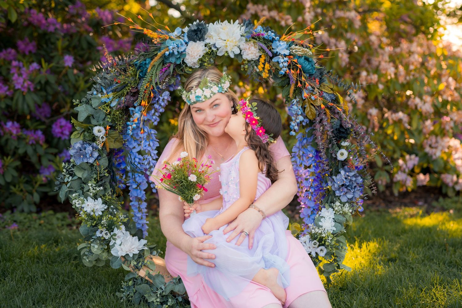 Mother holding daughter beneath handcrafted floral hoop at Kings Navy Yard Park in Amherstburg, Ontario.