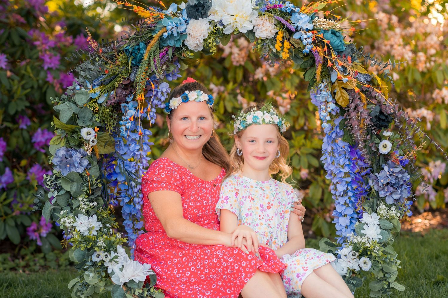 Close-up portrait of a mother and daughter sharing a smile during a spring photography session.