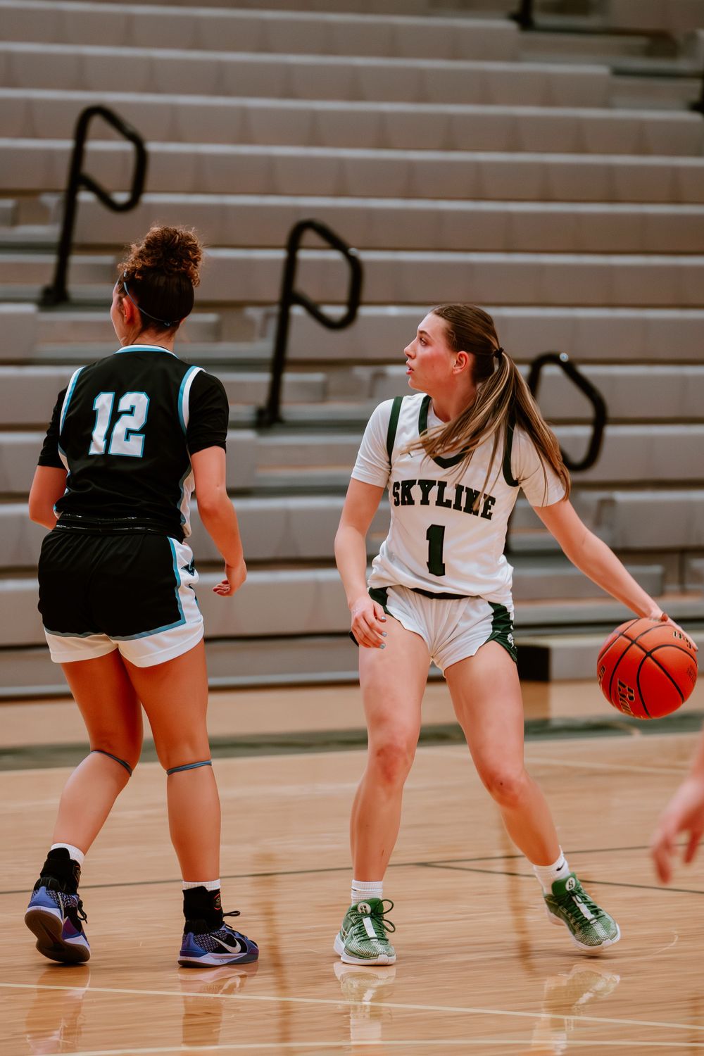 Basketball players from opposing teams face off during a competitive game.