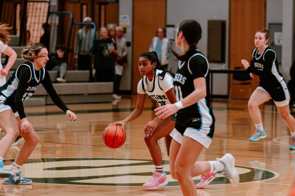 Basketball players from both teams compete for possession during fast-paced game action.