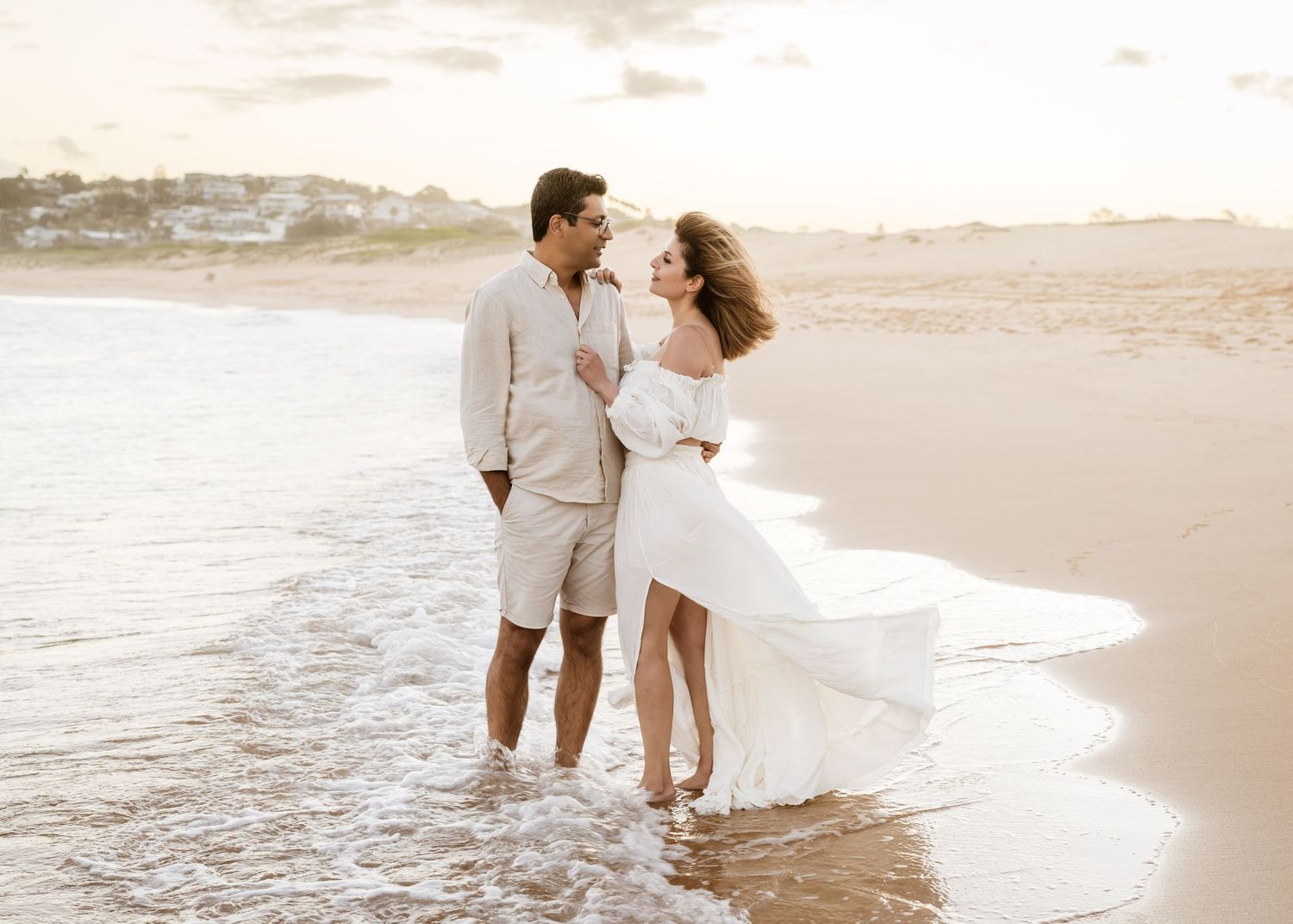 candid moment between engaged couple during sunset shoot in Northern Beaches