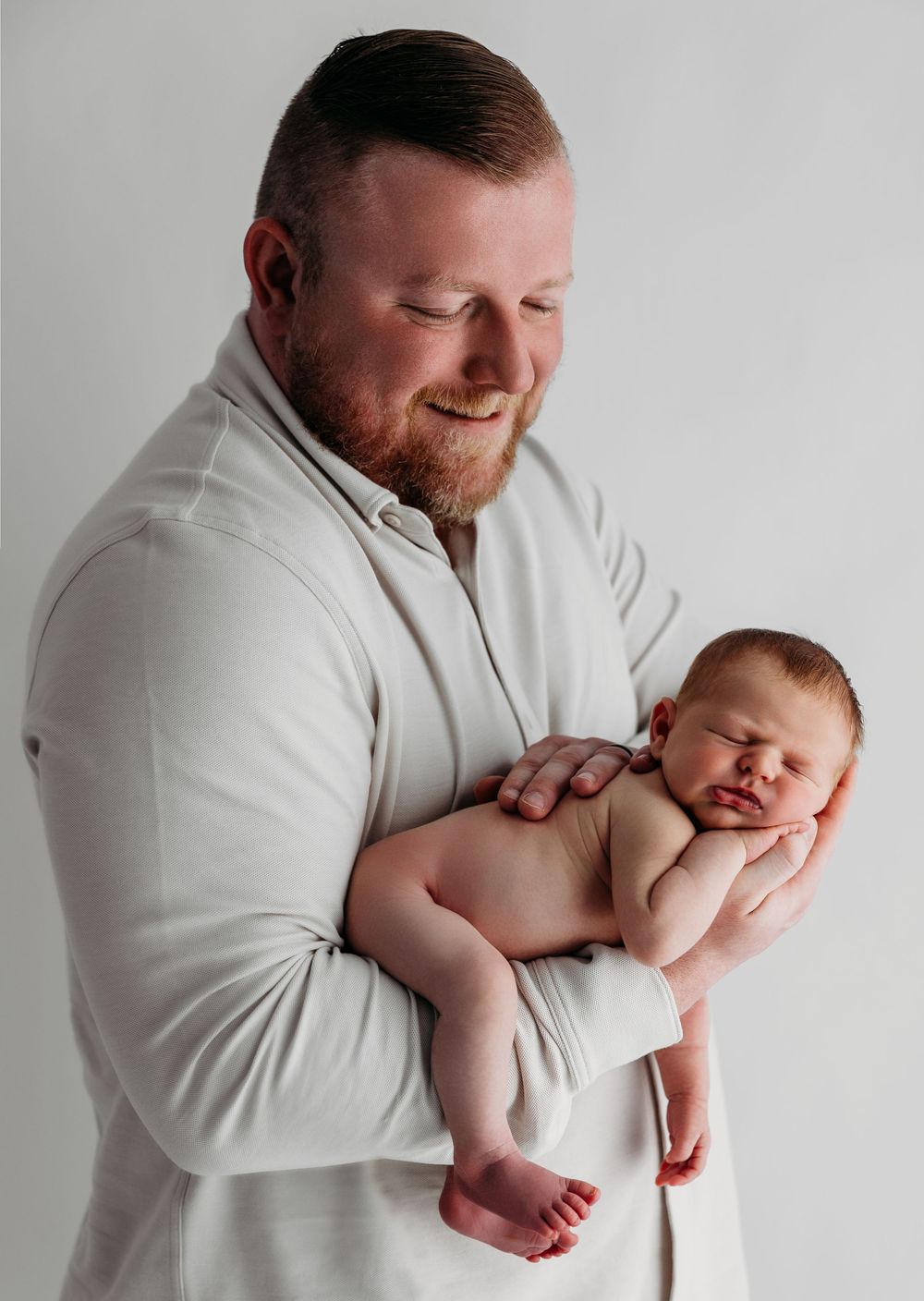 A series of tender moments captured between a baby and person wearing white, showing various gentle holding positions.