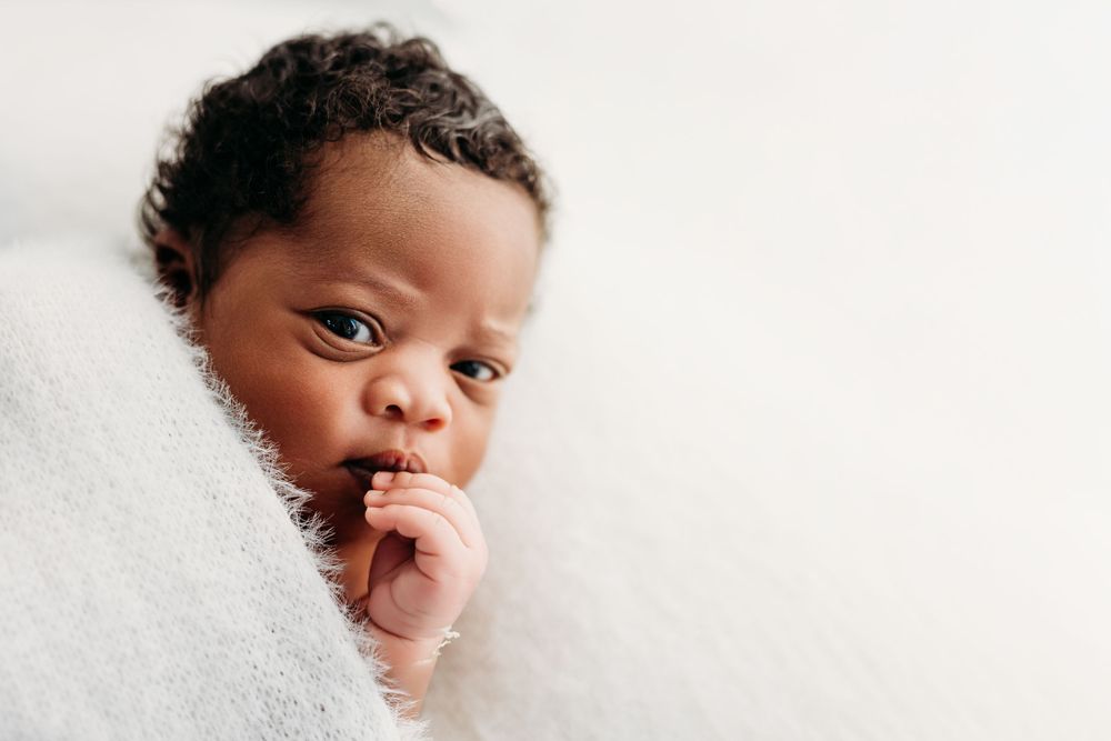 A small child wrapped in a soft white blanket in Fairfax, VA
Rashinphotography-Nova photographer-