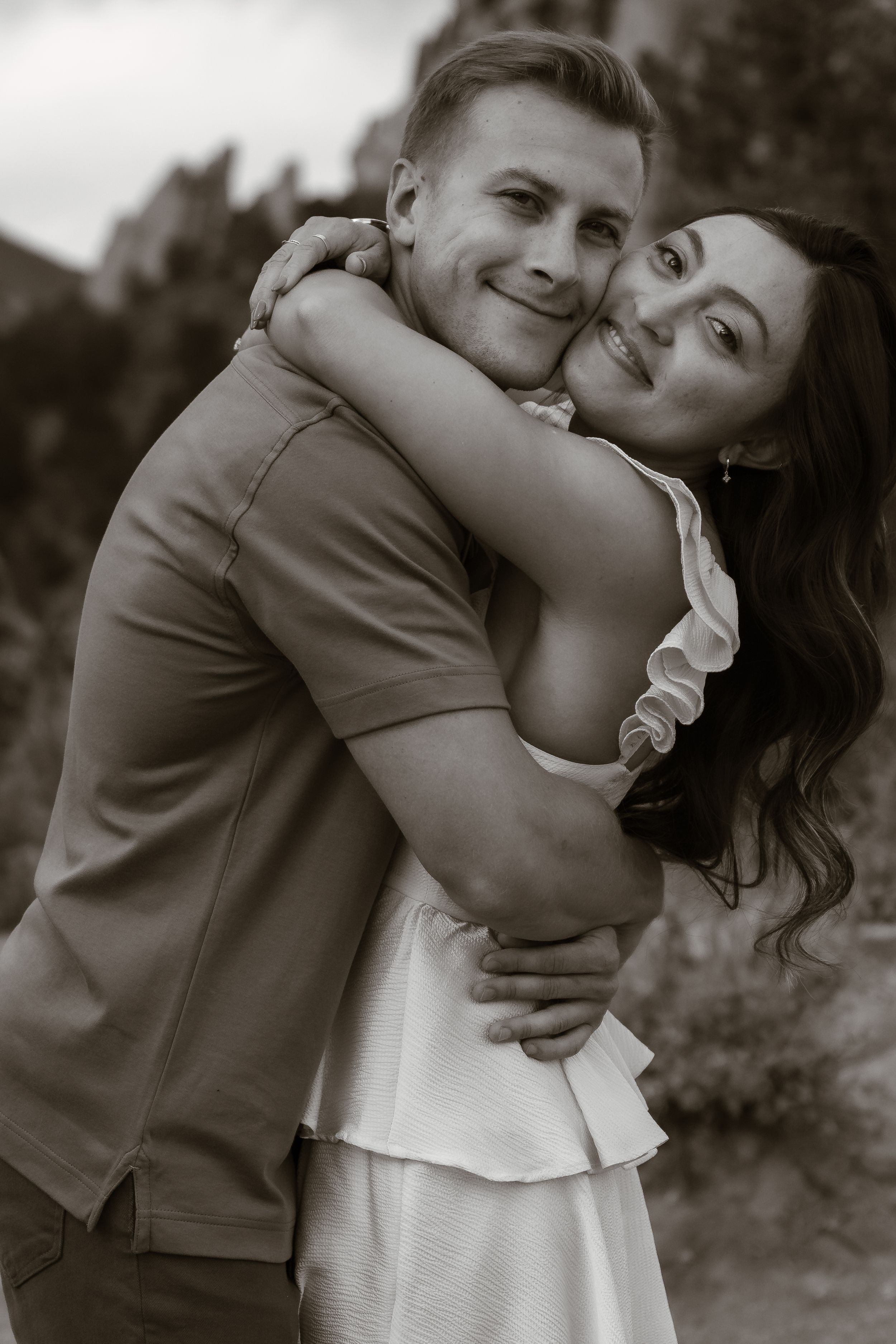 A series of black and white photos showing an intimate embrace between a couple.