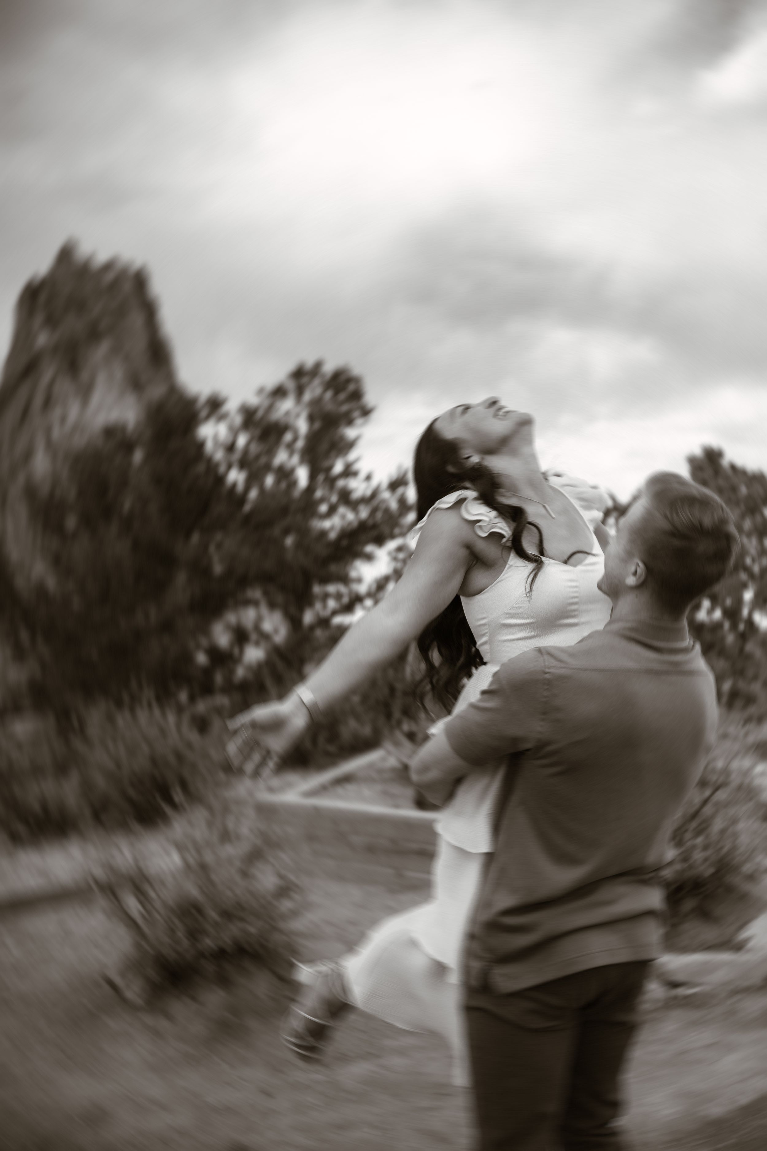 A black and white sequence shows a couple spinning and dancing together outdoors.