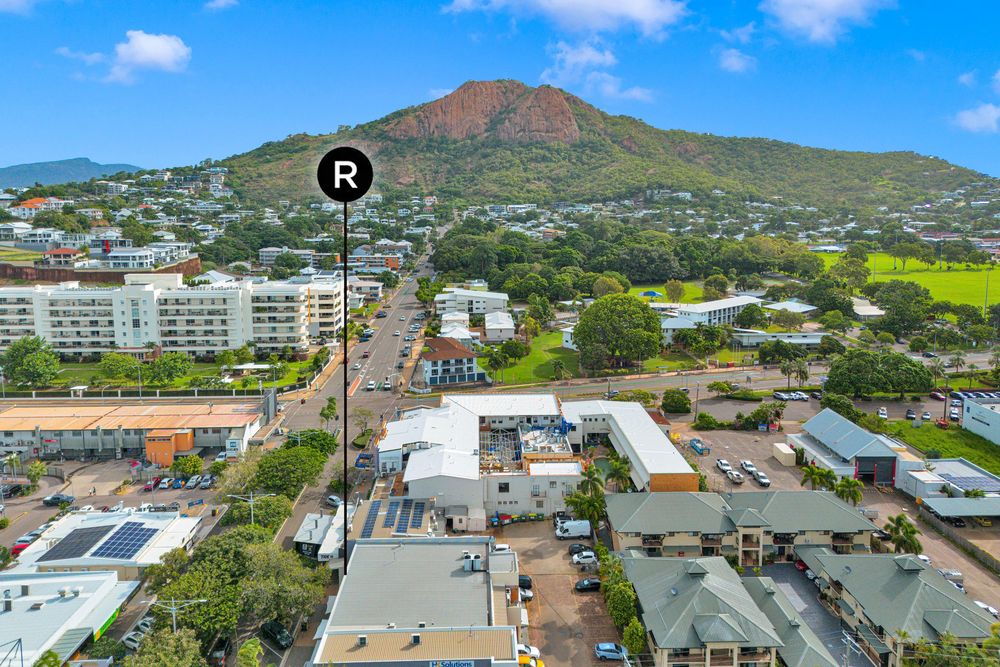 Aerial panoramic view of Honolulu city buildings and mountains under blue sky with white clouds in Hawaii.