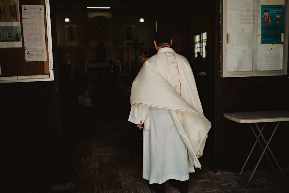 The priest entering the church, marking the beginning of the heartfelt wedding ceremony