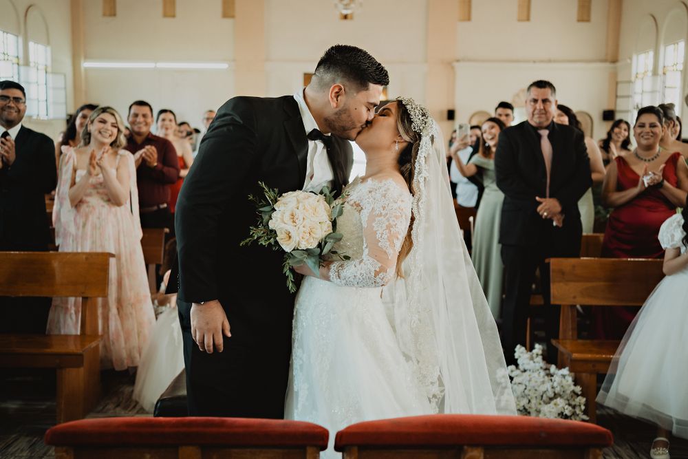 The couple's first kiss at the altar, a magical moment every wedding photographer dreams of capturing