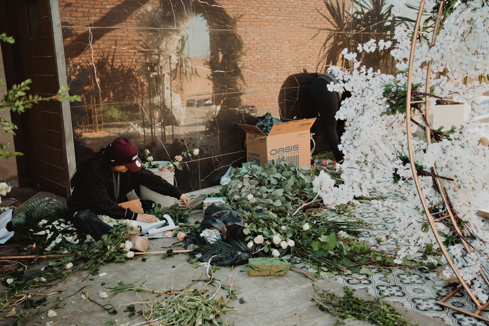Florists preparing the arrangements at the reception, ensuring every detail is perfect for the wedding