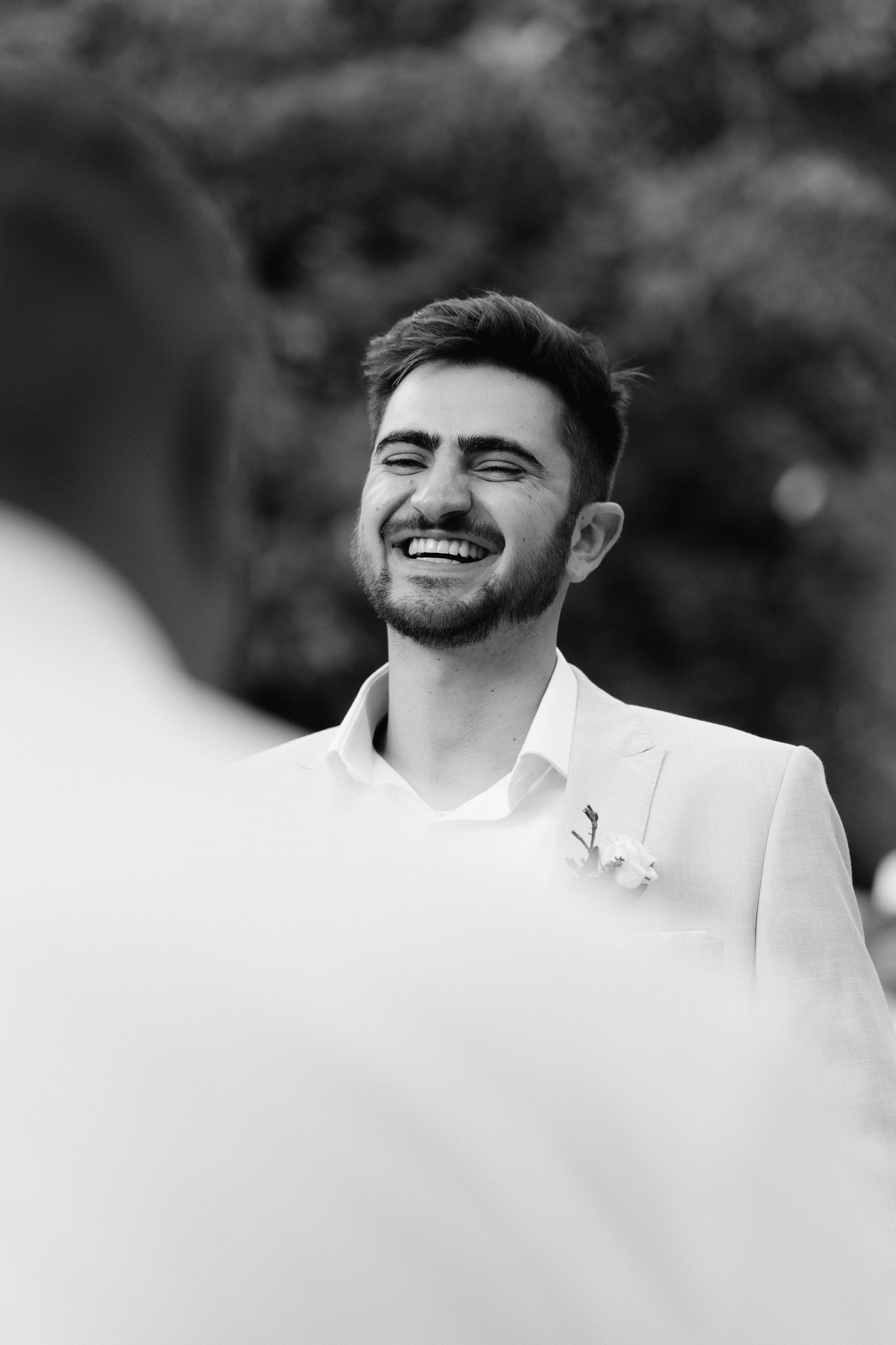 Black and white candid shots capture joyful reactions at a wedding celebration.