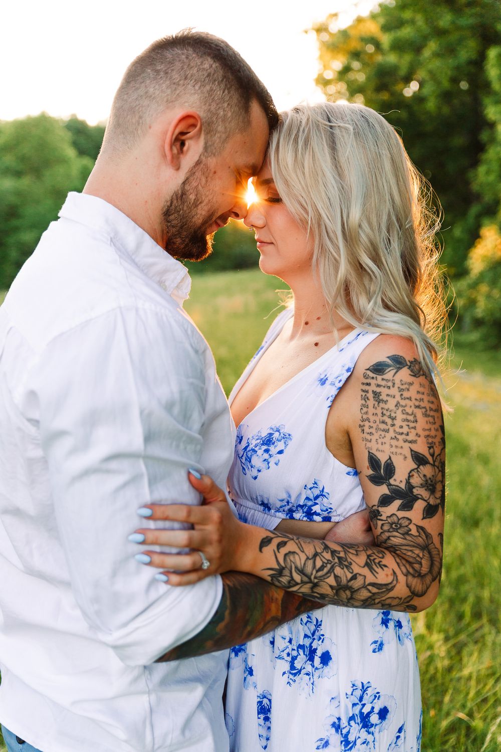 Intimate portraits of a couple embracing outdoors with visible tattoos.
