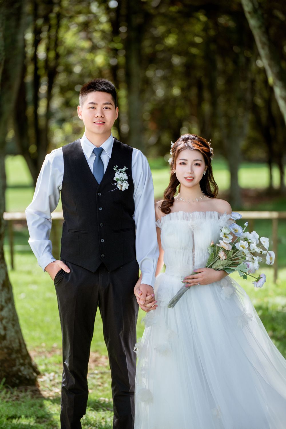 Beautiful outdoor wedding photography of a couple among green trees at One Tree Hill, by an Auckland wedding photographer.