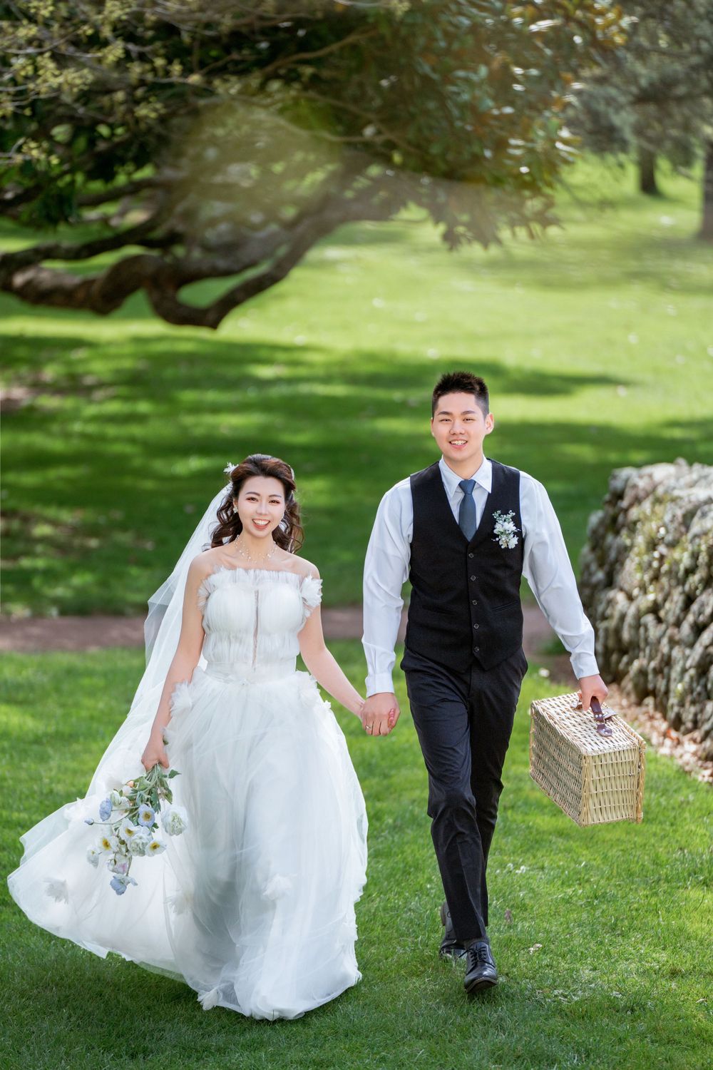 Beautiful outdoor wedding photography of a couple among green trees at One Tree Hill, by an Auckland wedding photographer.