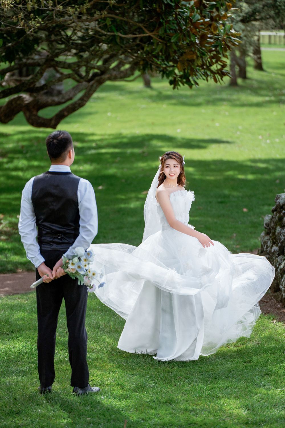 Beautiful outdoor wedding photography of a couple among green trees at One Tree Hill, by an Auckland wedding photographer.
