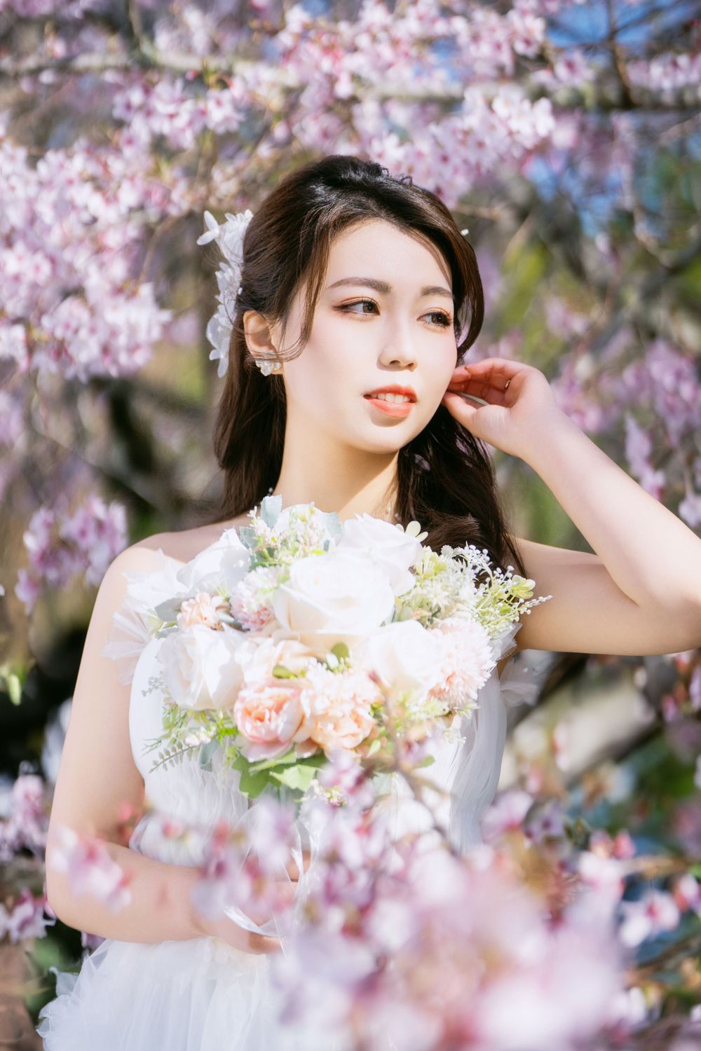 Romantic cherry blossom wedding photography featuring a couple in spring bloom, captured by an Auckland wedding photographer.