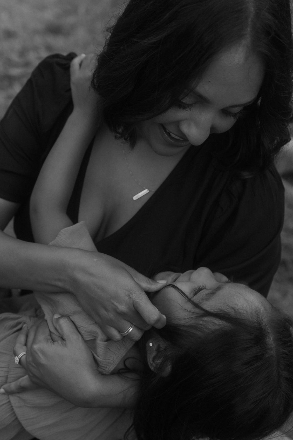 An intimate black and white portrait capturing a tender parenting moment.