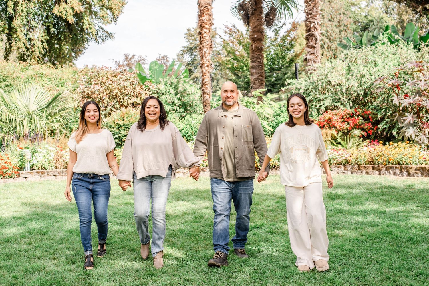 A series of candid walking shots on grass and pathways showing casual family moments in an outdoor setting.