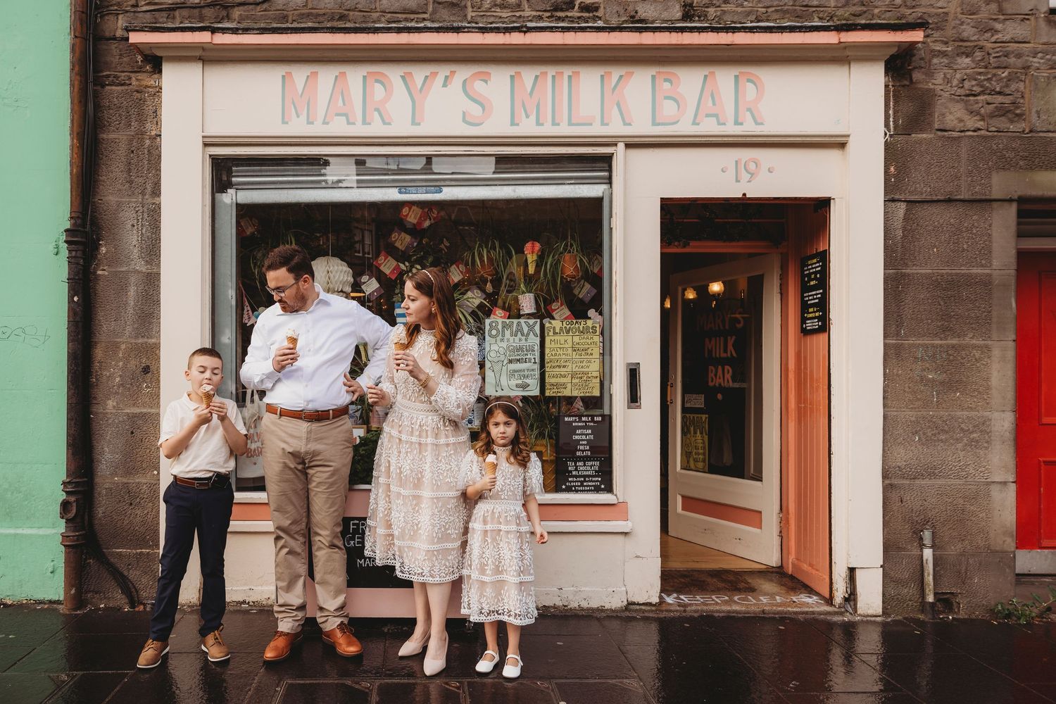 Vintage storefront with green walls and large windows displays Marie's Milkbar signage above the entrance.