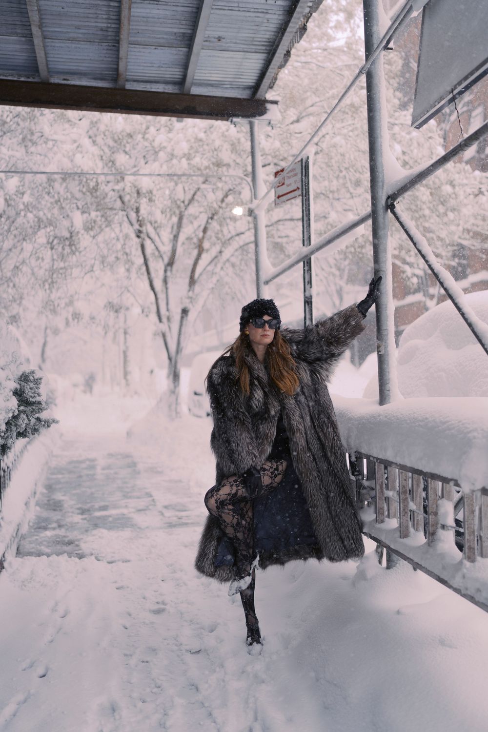 A sequence of photos showing a person playing in deep winter snow near a covered porch.