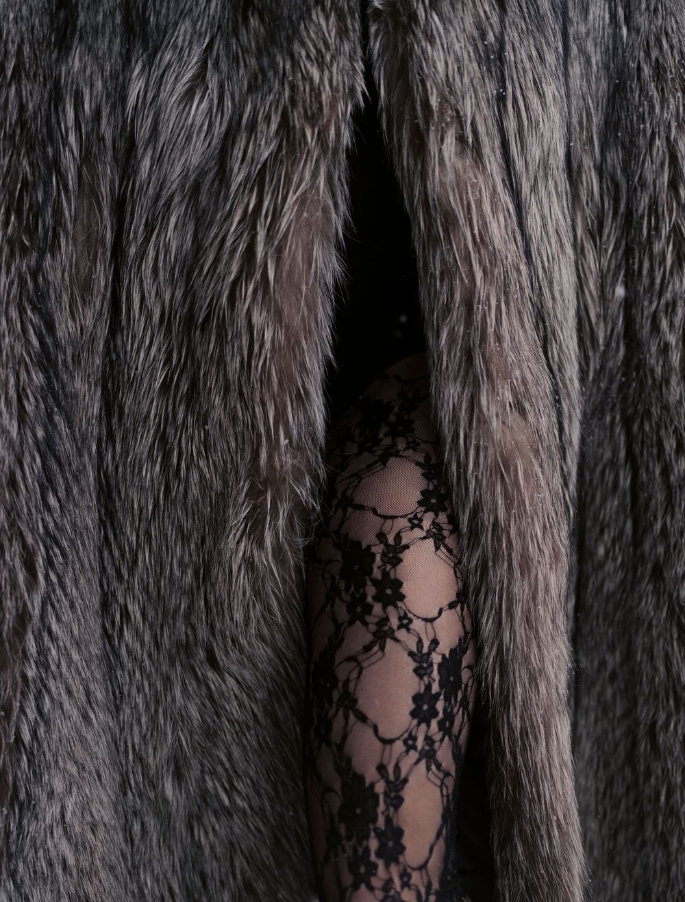 Close-up textural detail of grey faux fur fabric showing the intricate pattern and fibers.