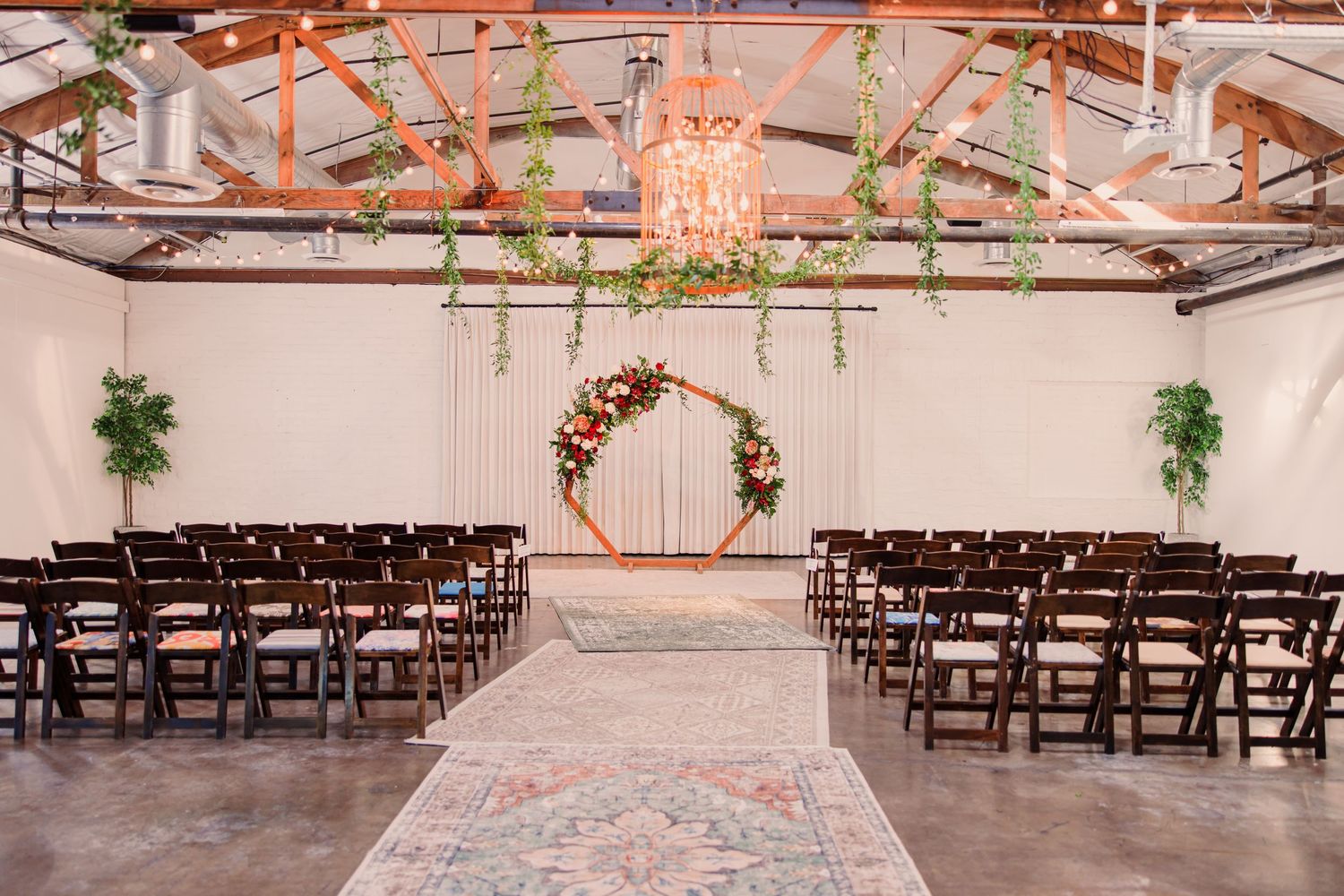 Black and white wedding photos showing a bride in a flowing white dress with a long veil in an elegant hallway setting.