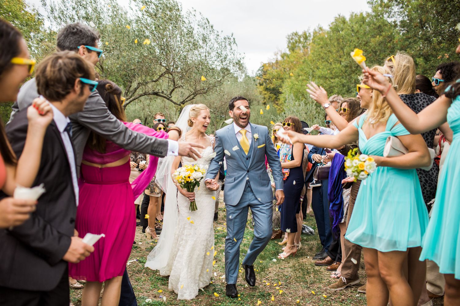 Bride and groom walking through guests during wedding celebration at Comptoir Saint-Hilaire Provence