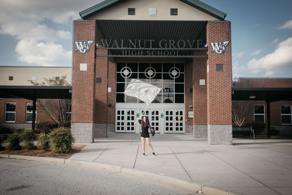 Exterior views of Walnut Grove school building entrance and facade on a sunny day with blue sky.