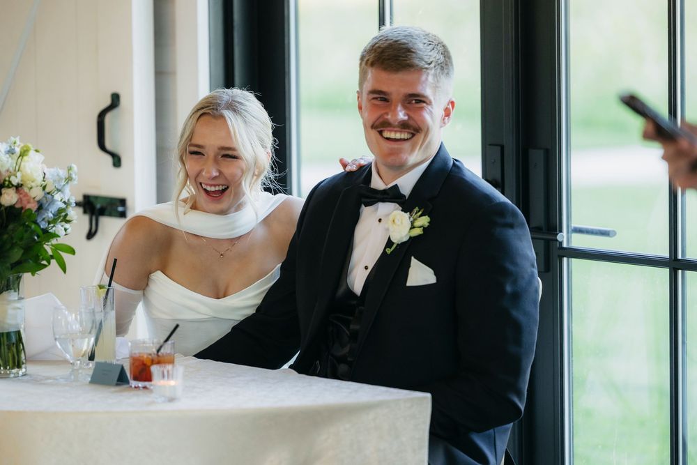 Candid moments of laughter and joy shared between a couple during their wedding celebration.
