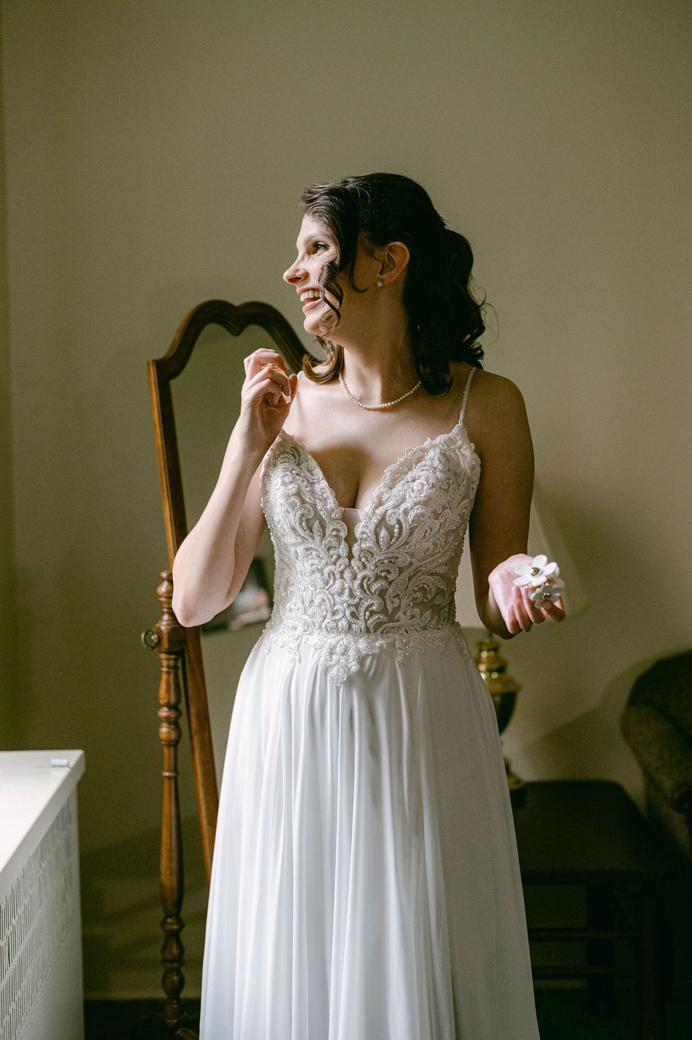 A flowing white wedding dress with delicate lace bodice and sheer straps shown in a series of detail shots.