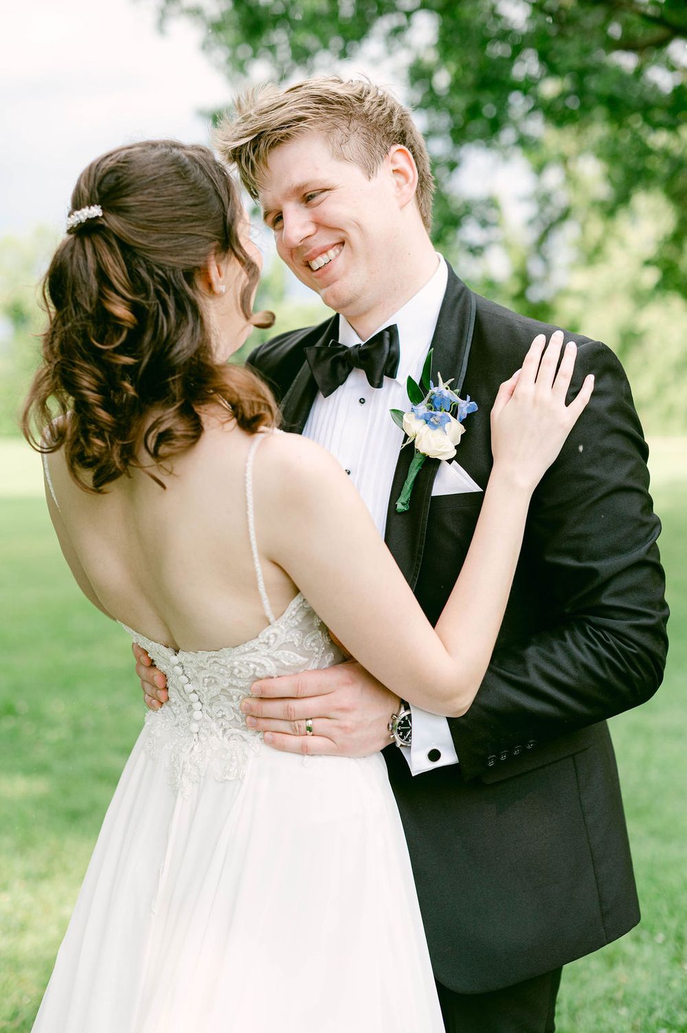A romantic wedding couple shares intimate moments in a garden setting, captured in a series of tender poses.