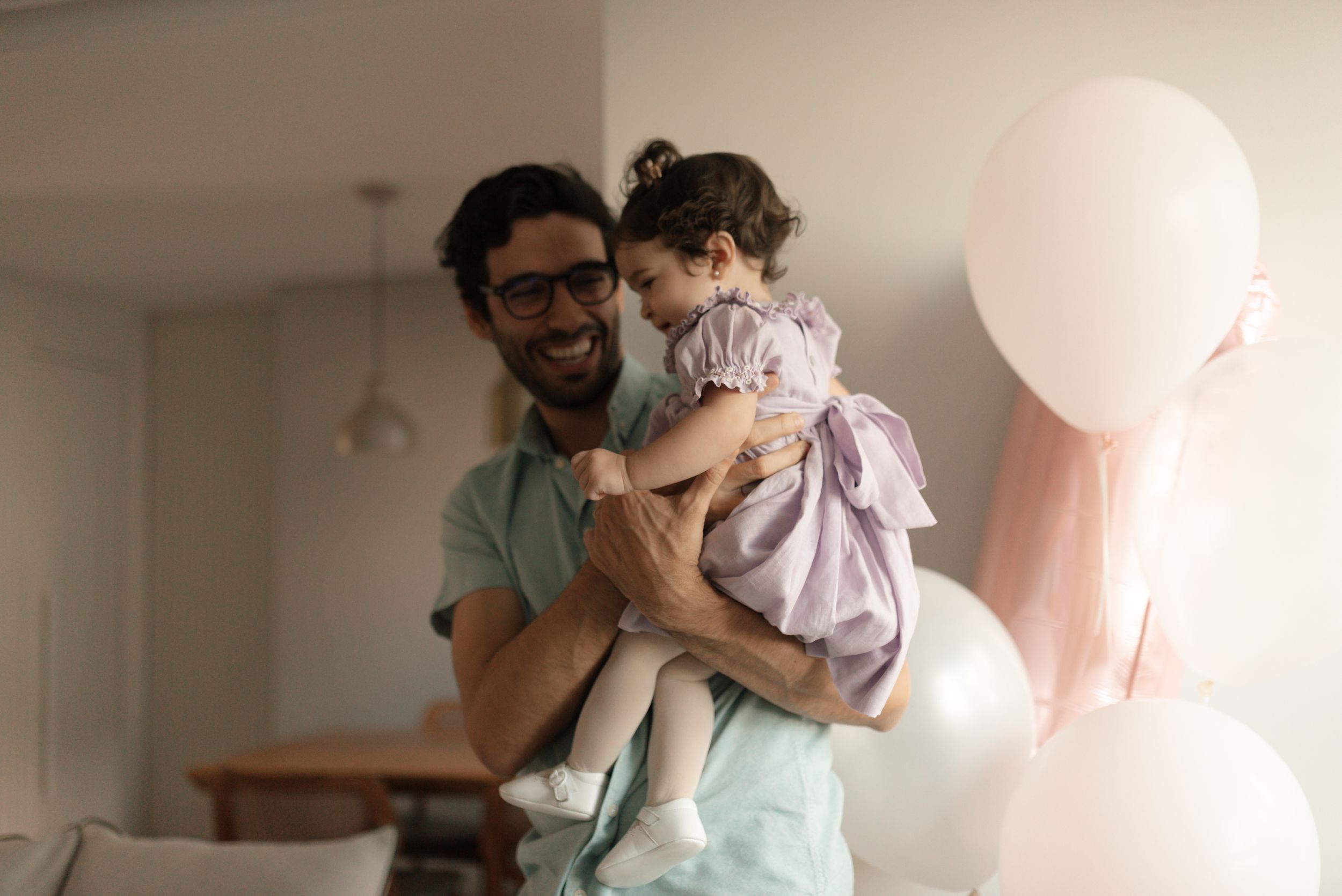 A parent and child share tender moments together in a series of intimate indoor photographs.