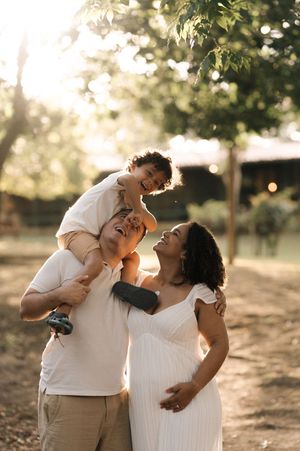 A couple shares tender moments during a sunset photo session in a park setting.
